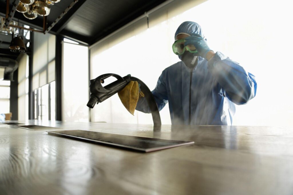 man spraying for disinfection in the office